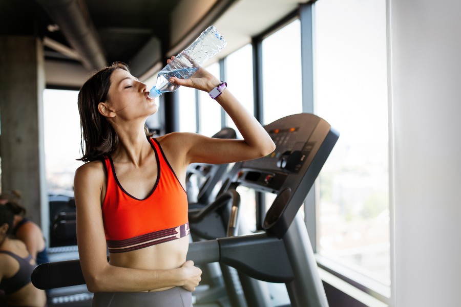 girl drinking water treadmill